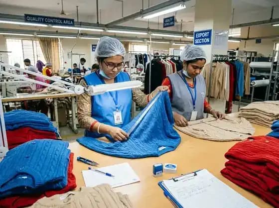 Inspector checking a knit garment at the quality control table