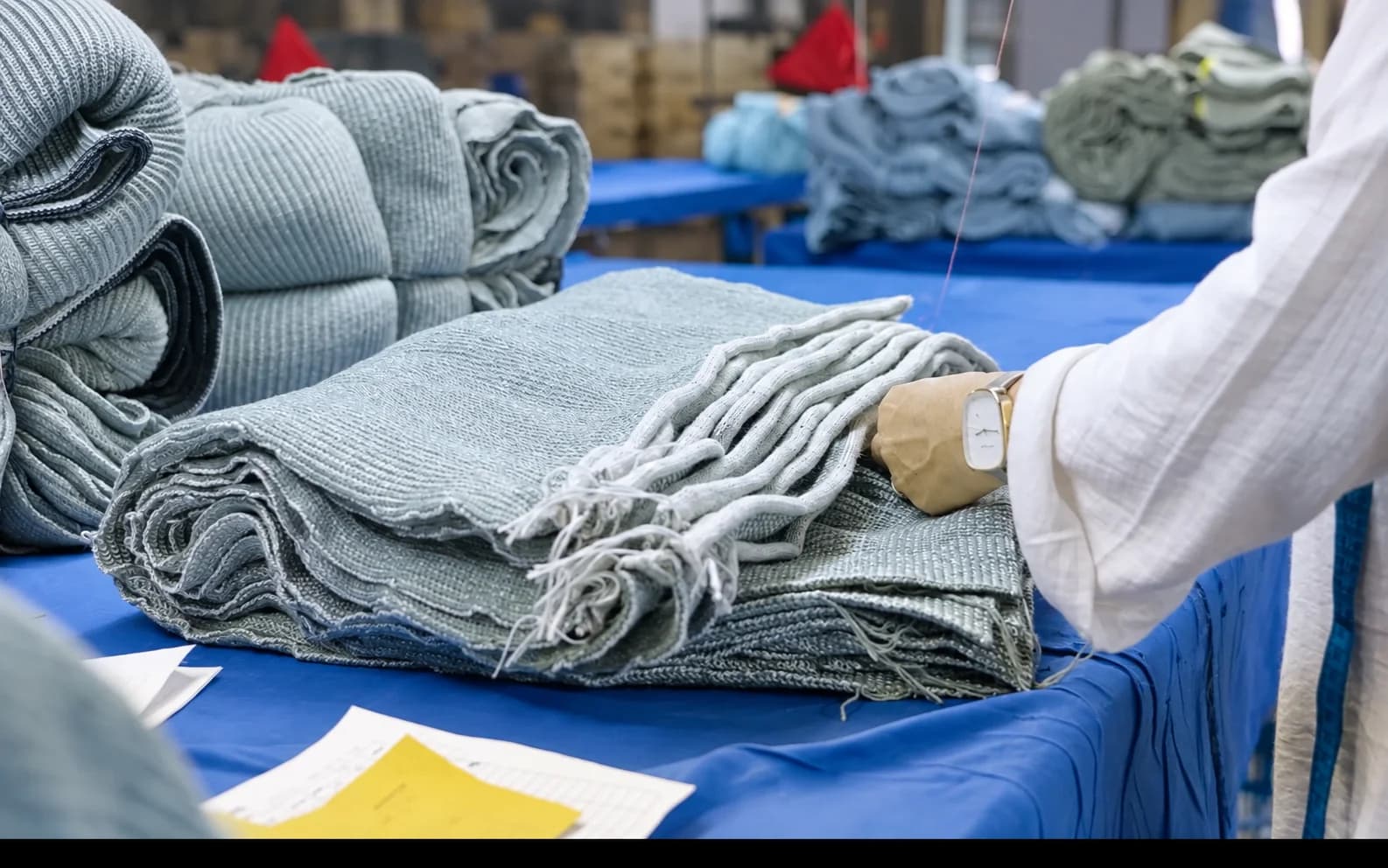 Measuring tape on a knit garment at the inspection table